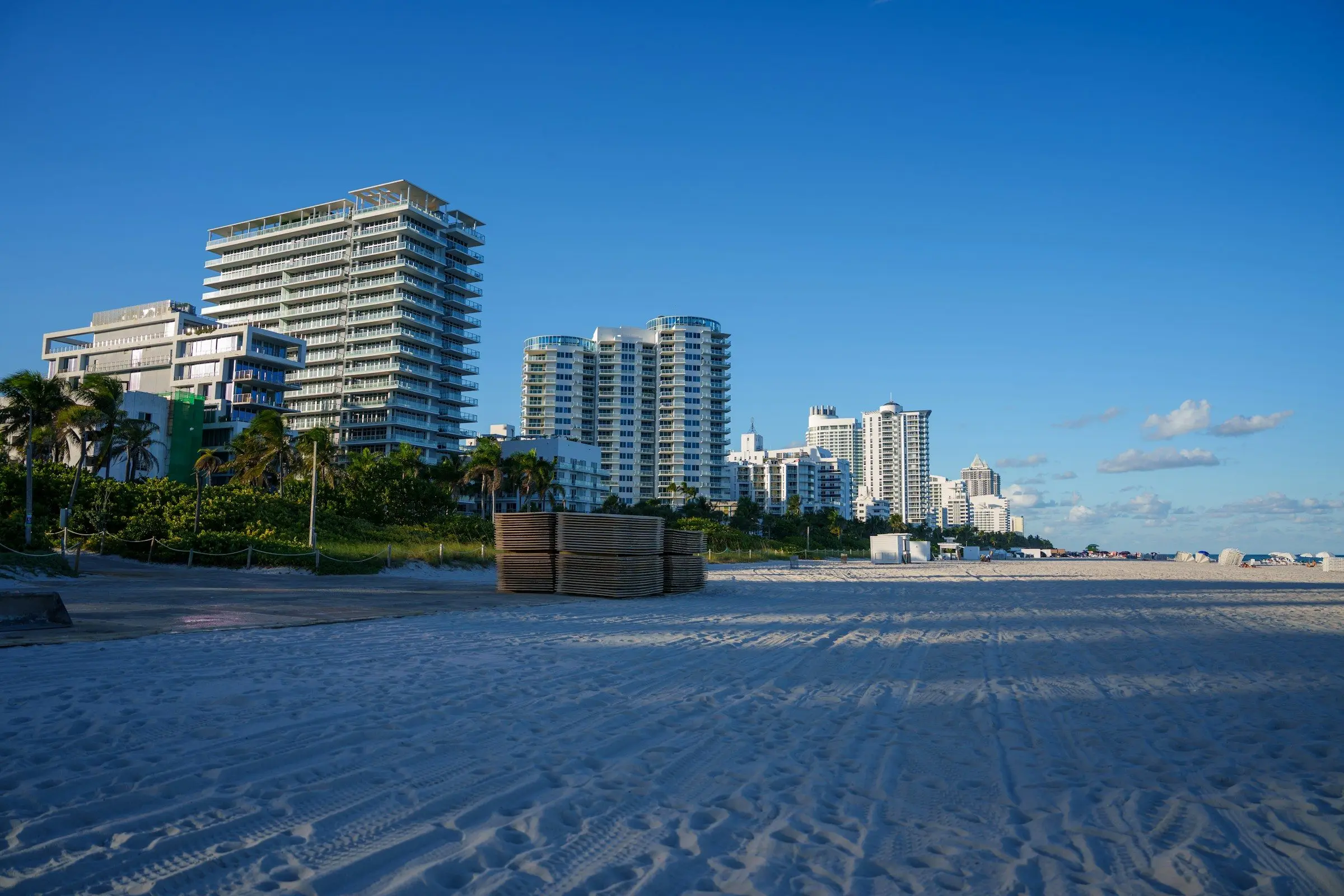 White high-rise condos along a wide sandy beach
