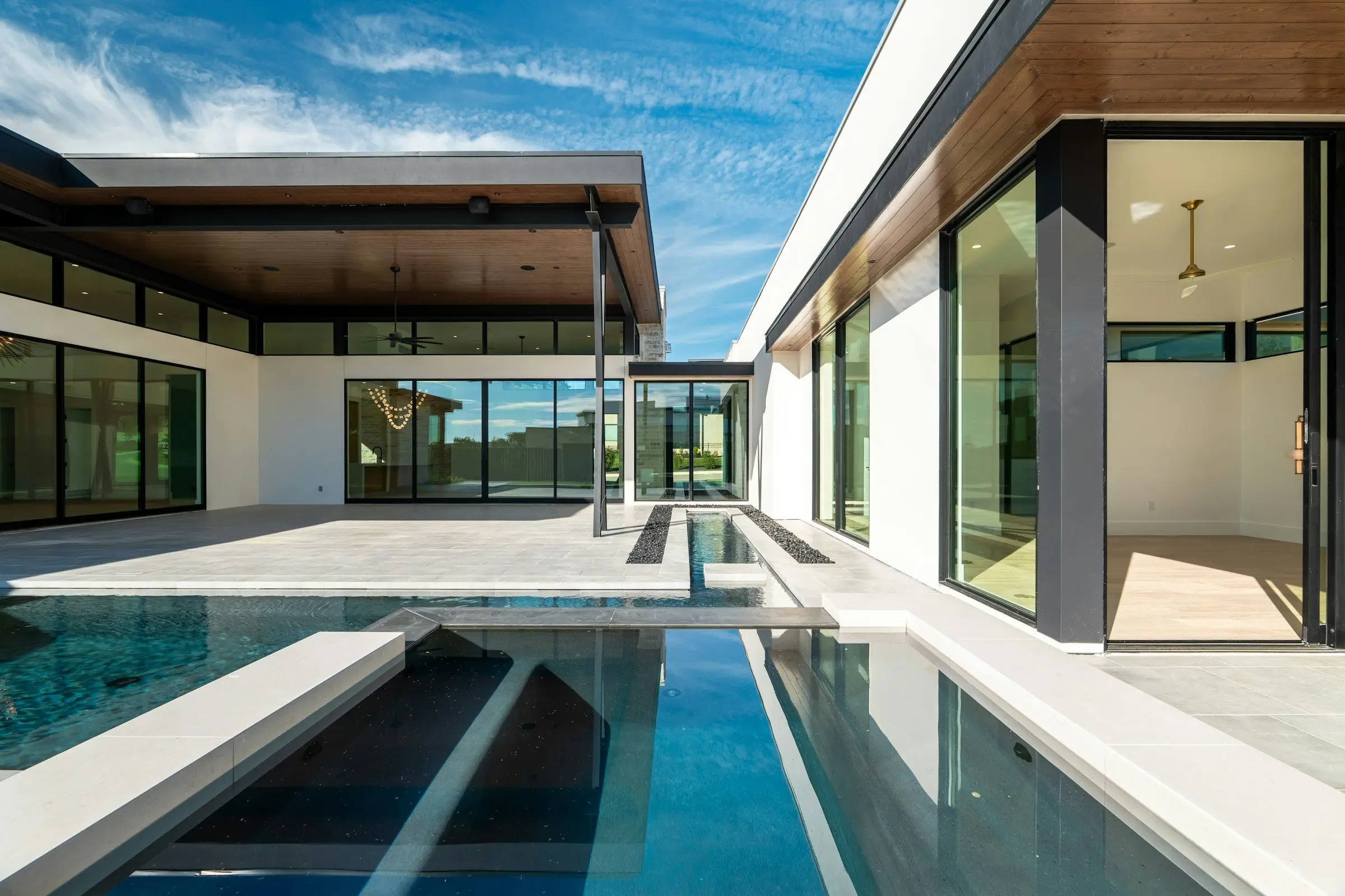 A sliding glass door open onto a screened Florida lanai
