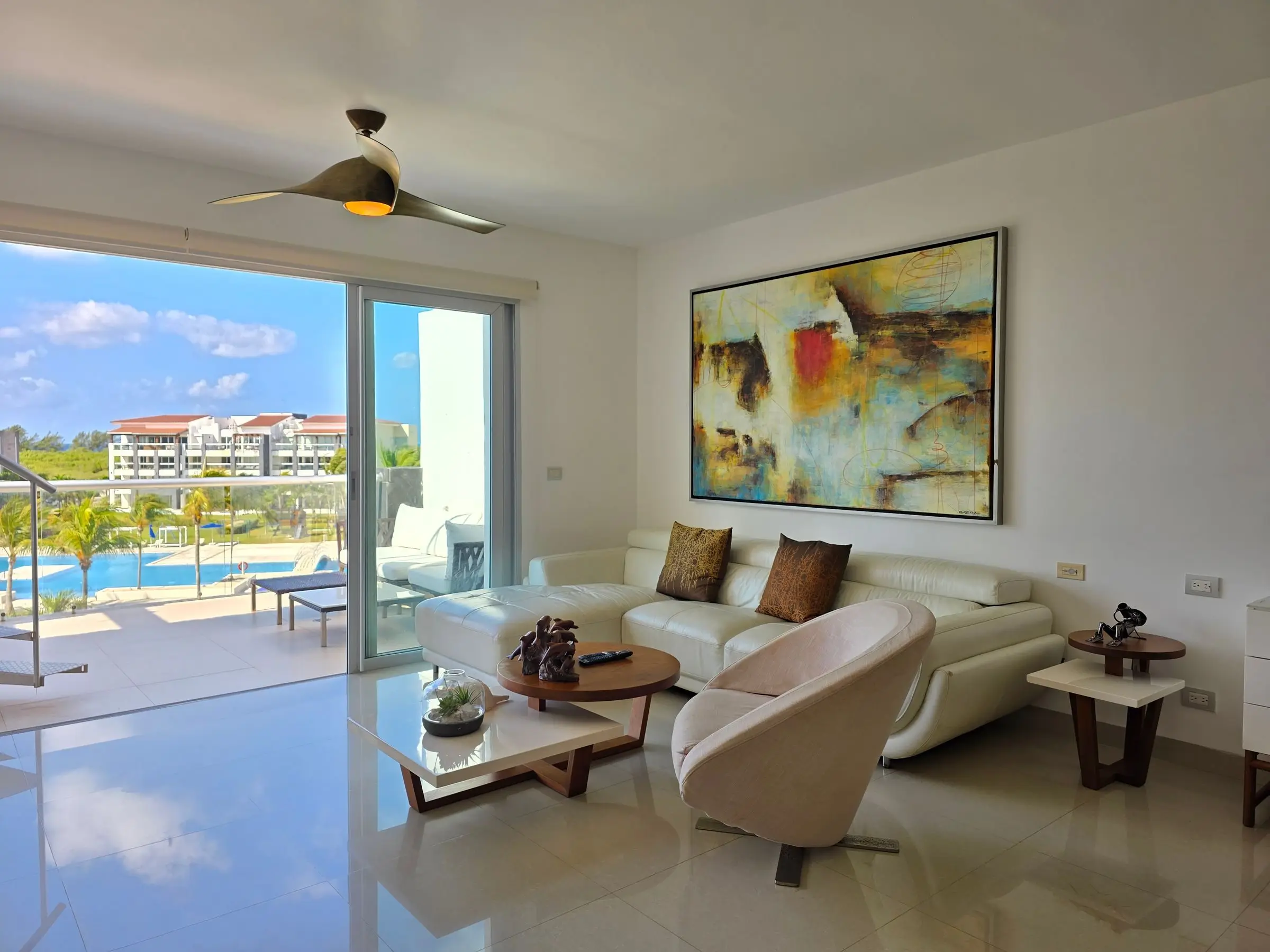A white-framed patio slider standing open onto a condo balcony