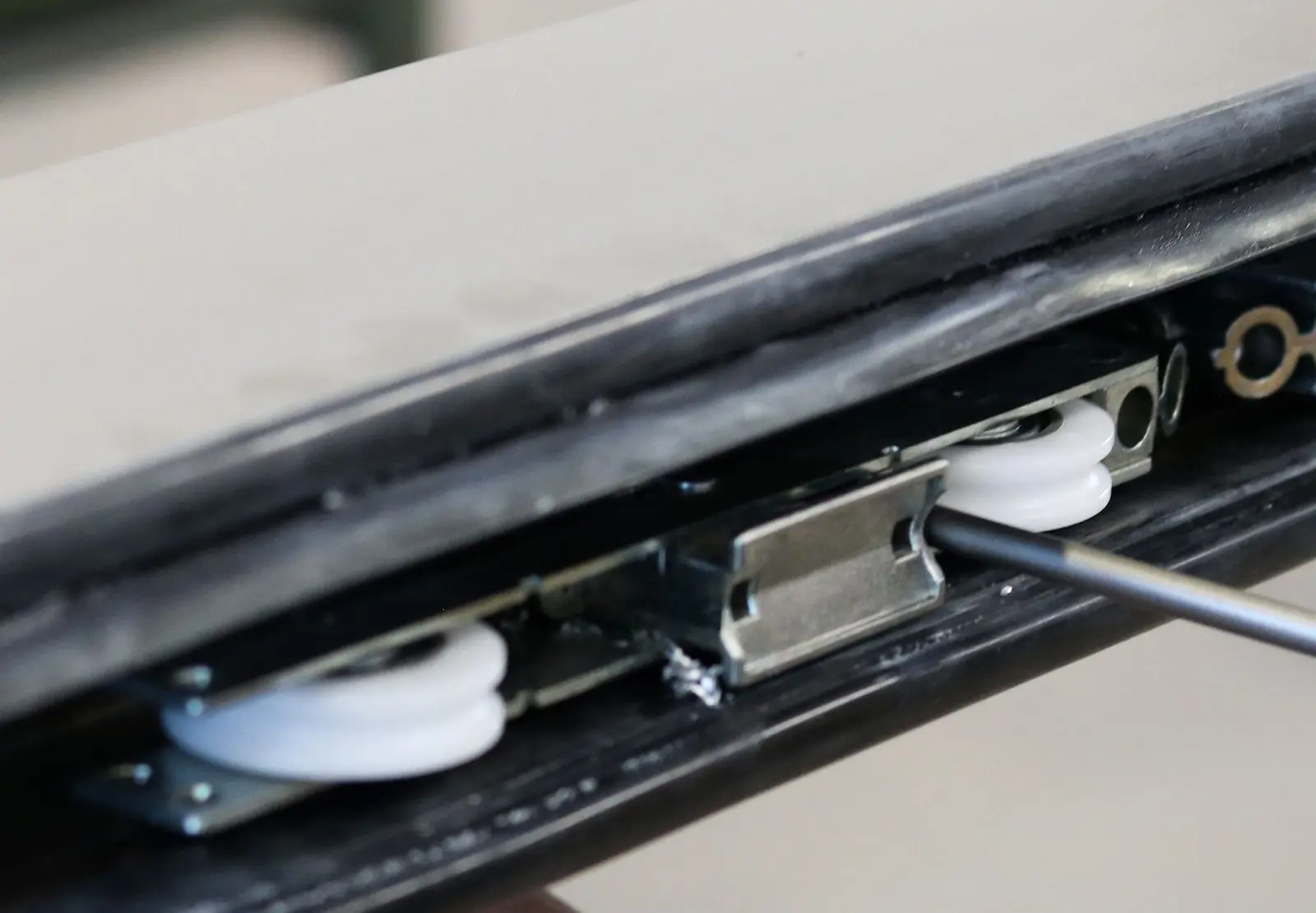 Close-up of a sliding door roller wheel